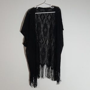 A black lace cardigan with tassels at the bottom